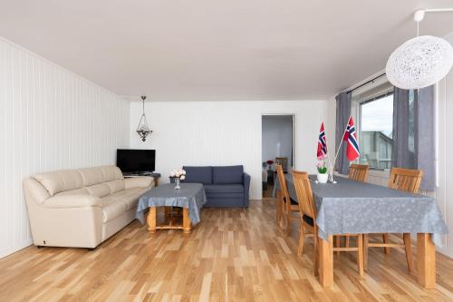 a living room with a couch and a table at Apt 102 - Andenes Whale Safari Apartments in Andenes