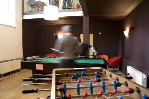 two men playing pool in a room with snooker at Jugendgästehaus des CVJM Berlin-Kaulsdorf in Berlin