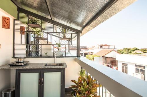 a balcony with a sink and a view of a building at HOI AN HEART LODGE in Hoi An