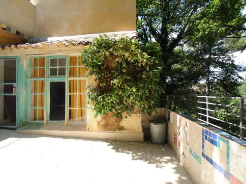 a house under construction with a window and a tree at Le Quinquerlet in Apt