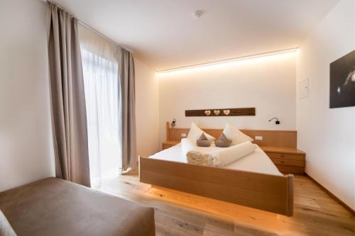 1 dormitorio con cama y espejo grande en Sonnleiten Sonnenparadies en Collepietra