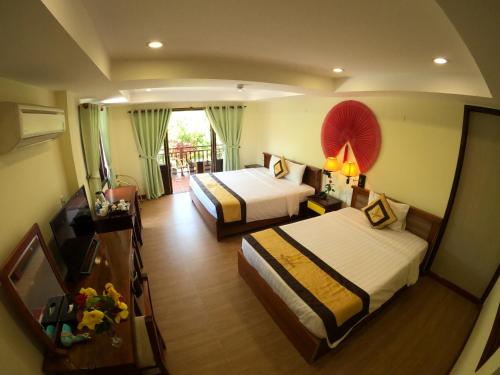 Postel nebo postele na pokoji v ubytování Vela Phu Quoc Resort