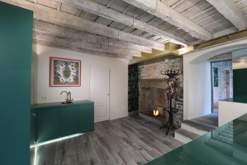 a living room with wood ceilings and a fireplace at Suites&Atelier Lake Como in Como