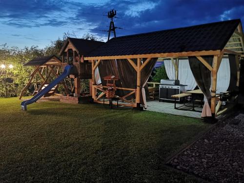 a gazebo with a slide and a playground at Ośrodek Wypoczynkowy Bernadetta in Murzasichle