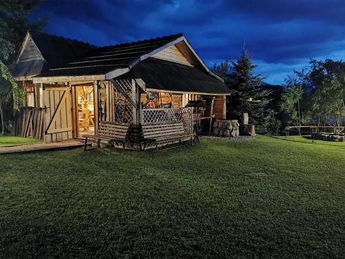 a log cabin with a porch in a yard at Ośrodek Wypoczynkowy Bernadetta in Murzasichle
