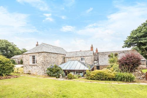 an exterior view of a stone house with a lawn at Trehellas House Hotel & Courthouse restaurant in Bodmin