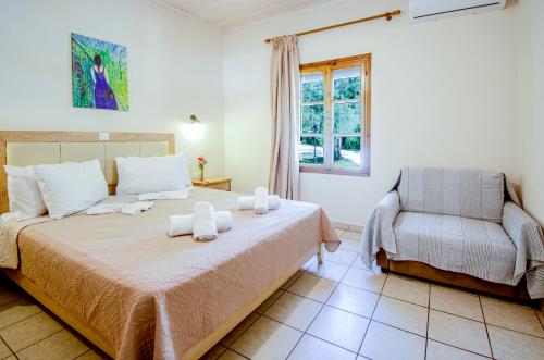 a bedroom with a bed and a chair at Lucia's Home in Skala Potamias