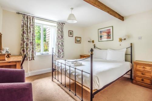 a bedroom with a bed and a desk and a window at Trehellas House Hotel & Courthouse restaurant in Bodmin