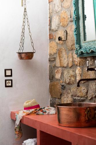 a sandwich sitting on a table next to a sink at Ta Petrina in Vourvourou