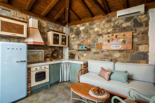 a kitchen with a couch and a table in a room at Ta Petrina in Vourvourou