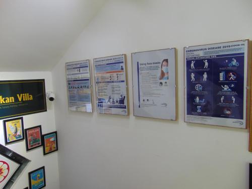 a group of posters on a white wall at SRI LANKAN VILLA in Galle