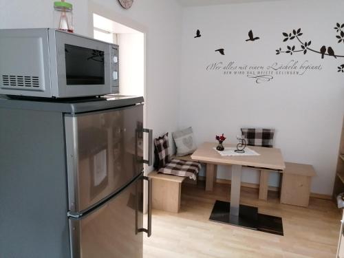 a kitchen with a microwave on top of a refrigerator at Gemütlich wohnen in Welling in Welling