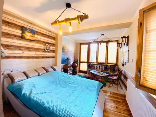 a bedroom with a bed and a table and chairs at Nemezis in Ustka
