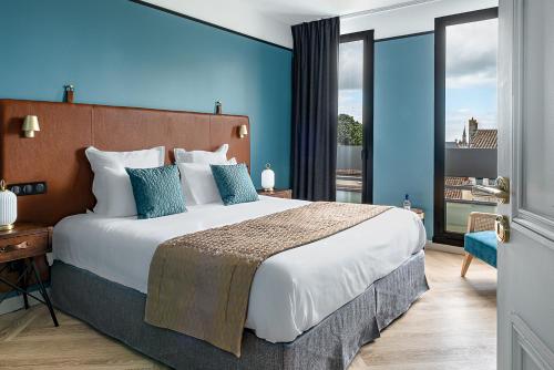 Ένα ή περισσότερα κρεβάτια σε δωμάτιο στο Maison des Ambassadeurs