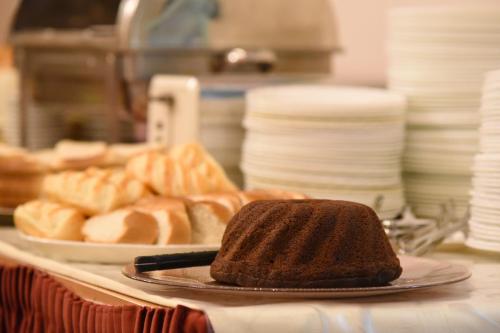 a plate with a piece of cake on a counter at Garten- und Kunsthotel Gabriel City in Vienna