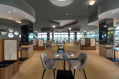 a restaurant with a table and chairs in a building at Hotel Katarina in Selce