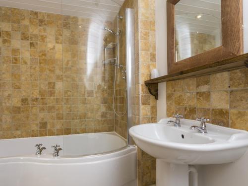 a bathroom with a sink and a toilet and a tub and a sink at Blue Ball Inn in Sidmouth
