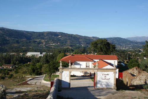 a small house with a red roof on a hill at Casa de Cartemil in Ponte de Lima