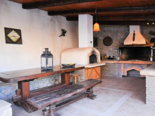 a kitchen with a wooden table and an oven at Studios Dimitra in Spartià