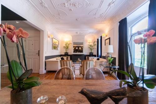 a living room with a table and chairs at Bliss Lisbon Apartments - Avenidas in Lisbon