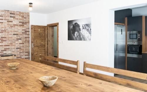 a kitchen and dining room with a wooden table at Apartmany JA&MA in Liptovský Mikuláš