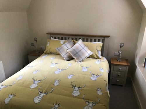 a bedroom with a bed with deer heads on it at North Lodge in Invergarry