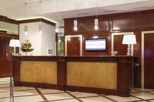 a lobby with a reception desk and a television at Hotel International Iasi in Iaşi
