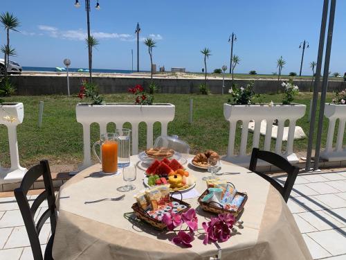 a table with a plate of food on it at Hotel Rivabella in Davoli