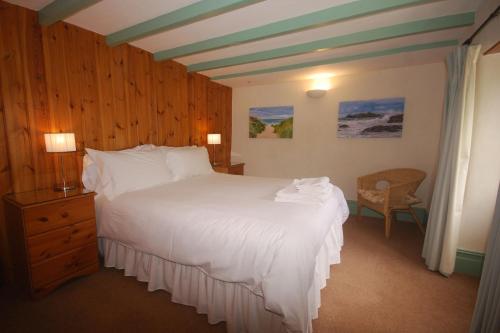 A bed or beds in a room at Granary at Trewerry Cottages - Away from it all, close to everywhere