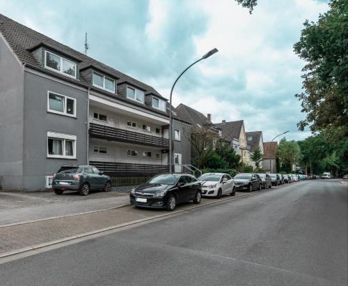 a row of cars parked on the side of a street at GATSBY Apartment in Gelsenkirchen