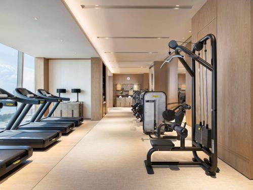 a gym with cardio equipment in a hotel room at Raffles Shenzhen, Situated in the heart of One Shenzhen Bay, Book Now to Enjoy Free Minibar and Happy Hour Privileges at Long Bar on 71F in Shenzhen