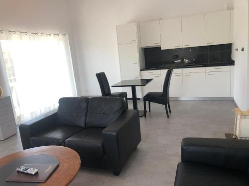 a living room with a couch and a table at Hotel Hippel Krone in Kerzers
