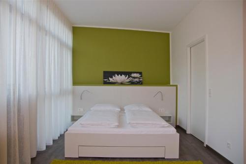 Ένα ή περισσότερα κρεβάτια σε δωμάτιο στο Boardinghouse Offenbach Service Apartments