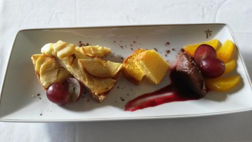a plate of food with grapes and fruit on it at Parador de Ferrol in Ferrol