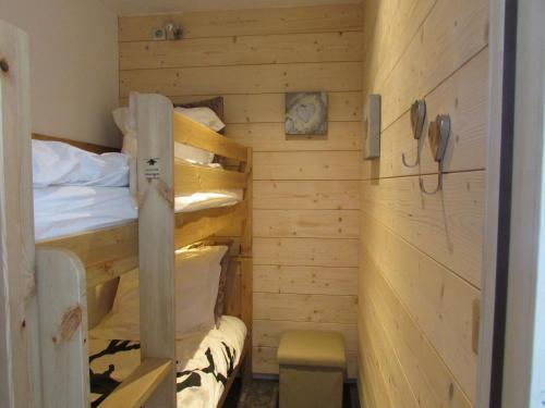 a room with two bunk beds and a phone at Residence Pierra Menta in Arc 1800