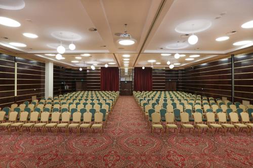 an empty room with chairs in a building at Hotel International Iasi in Iaşi