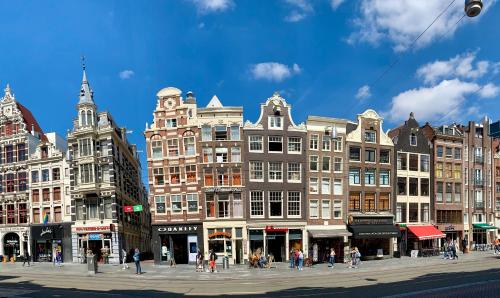 a group of buildings on a city street at Hotel Damrak Inn in Amsterdam