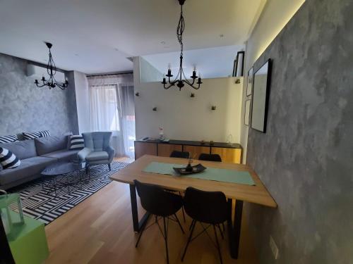 a kitchen and living room with a table and chairs at Apartman Natasa sa podzemnom garažom in Banja Luka