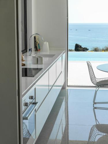 a kitchen with a view of the ocean at Mimi and Coco Villas Corfu in Paramonas