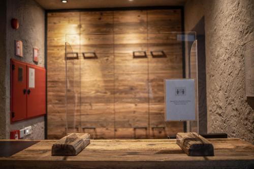 a room with a wooden wall with a glass door at Sonnleiten Sonnenadler 2 in Collepietra