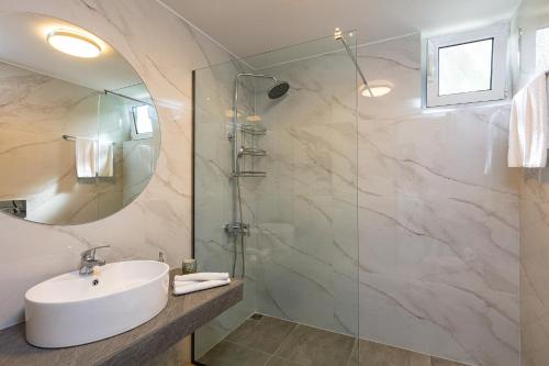 a bathroom with a sink and a shower at MariAndry Villa, Secluded Retreat with Pool, BBQ & HotTub, By ThinkVilla in Episkopí- Rethimno