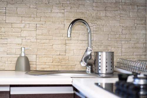a kitchen sink with a pot on a counter at Apartament Saski in Sandomierz