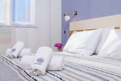 a bedroom with a bed with towels on it at Lavica Seaside Apartments, Podstrana in Podstrana