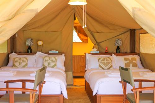 a bedroom with two beds in a tent at Enjoy the Silence, Naivasha by YourHost in Naivasha