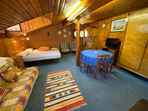 a room with a bed and a table in a room at Mansarda Villa Simonetta in Esino Lario