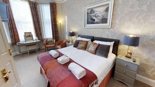 um quarto com uma cama grande e uma secretária em Glendower em Torquay
