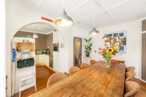 a dining room with a wooden table and a kitchen at The Eagle - 12 guests - Zwolle in Zwolle