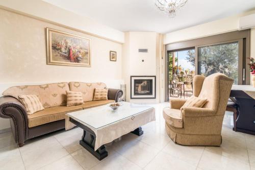 a living room with a couch and two chairs at Villa Olive Tree in Pitsidia