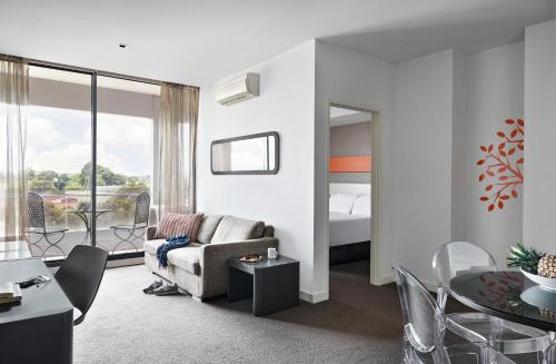 a living room with a couch and a table at Dandenong Central Apartments Official in Dandenong