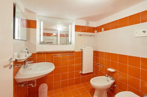 a bathroom with a sink and a toilet and a mirror at Villa Cuckoo's Nest in Finale Ligure